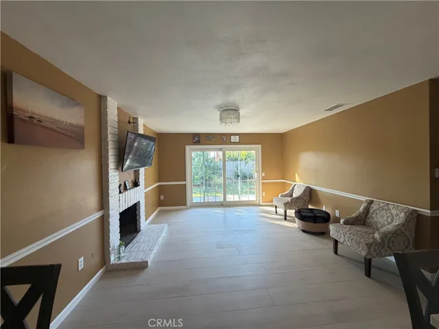 living room w gas fireplace and access to back yard