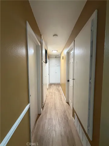 hallway with 2 separate linen cabinets