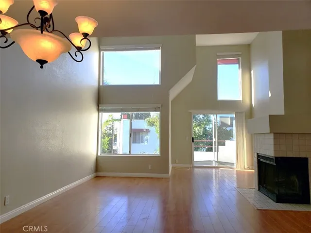 High ceiling living room with​​‌​​​​‌​​‌‌​​‌​​​‌‌​​​‌​​‌‌​​‌‌​​‌‌​​​​ fireplace.
