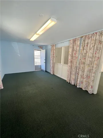 Same view with door open, which leads to pack parking and alley.