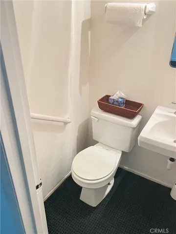 Private bathroom on one end of small treatment room