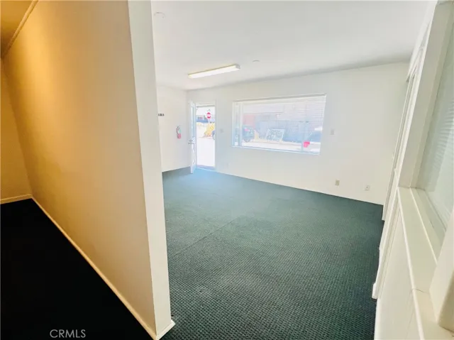 Small room behind reception room. Large enough for a massage table and to work around it.  Private bath is in that area.