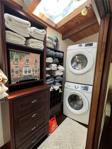 Laundry conveniently stacked along with linens and towels.