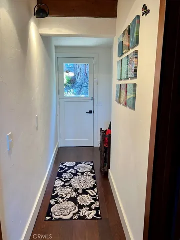 Hallway between the two main floor bedrooms, leads to back yard through a 'Dutch door'