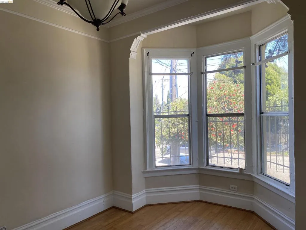 Bay window feature with a three-panel design, decorative trim, and security bars