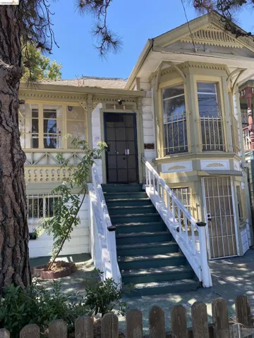 Victorian-style facade featuring ornate trim detailing and a bay window