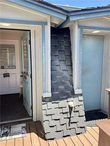 Entrance to foyer on left and locked private bathroom for shared use with 5 other units is on the right.