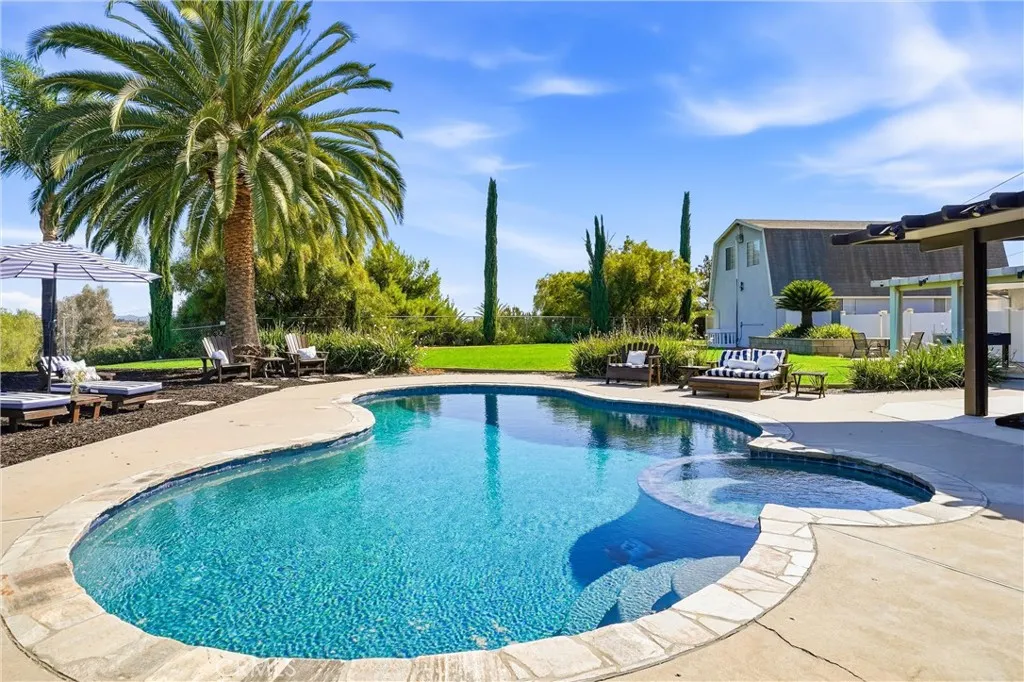 Pool, spa and the separate structure that looks like a barn.