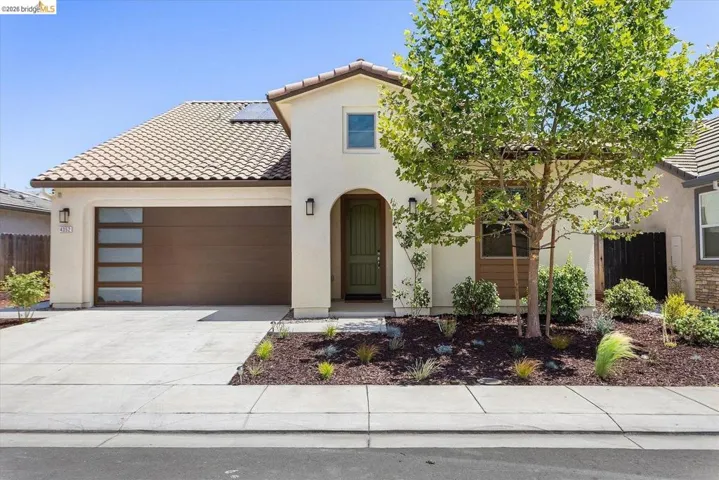 Contemporary stucco exterior with a tiled roof