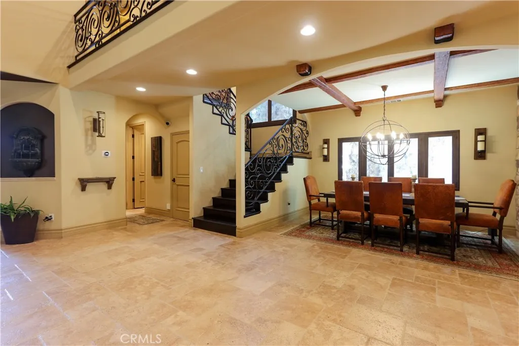 Open area towards dining, staircase, garage and powder room