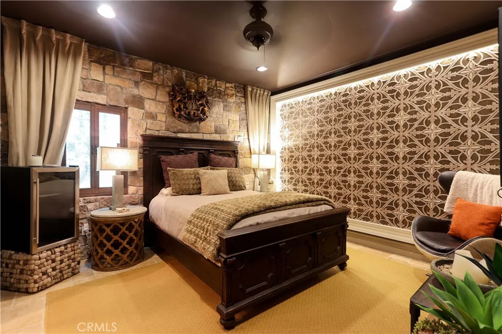 Bedroom 1 / Downstairs. There is a window to the front yard behind the lighted tapestry