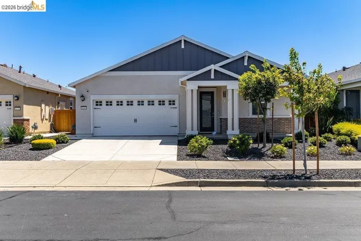 Contemporary stucco and siding exterior with a gabled roofline