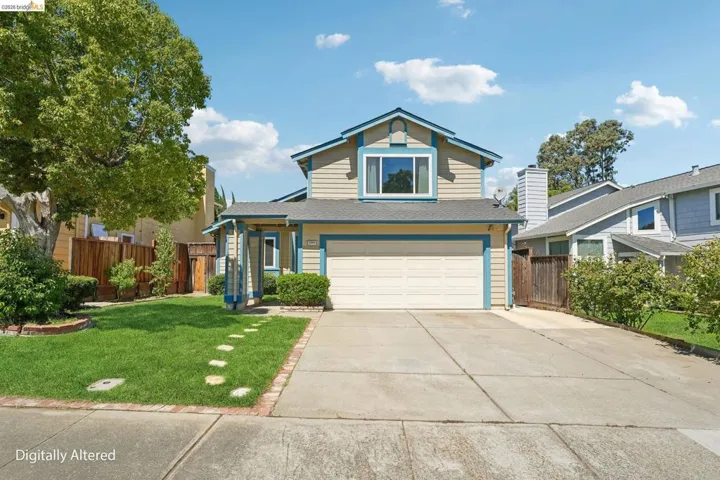 Two-story residence featuring light-colored siding with blue trim accents, an attached two-car garage, a concrete driveway, a manicured front lawn, and a mature​​‌​​​​‌​​‌‌​​‌​​​‌‌​​​‌​​‌‌​​‌‌​​‌‌​​​​ tree
