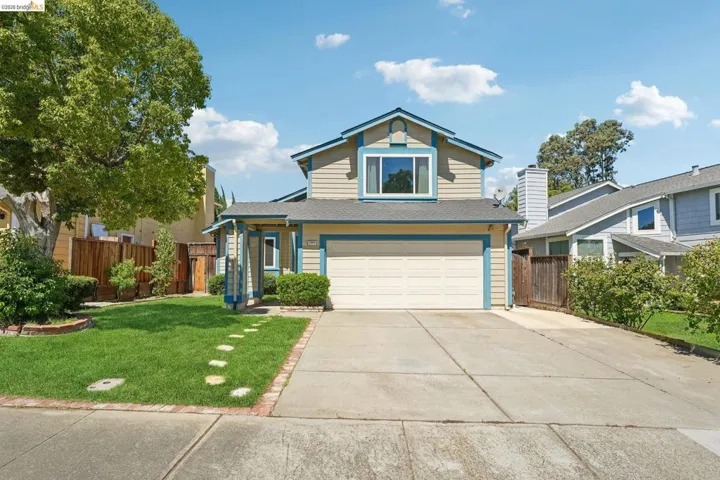 Two-story residence featuring light-colored siding with blue trim accents and a two-car garage
