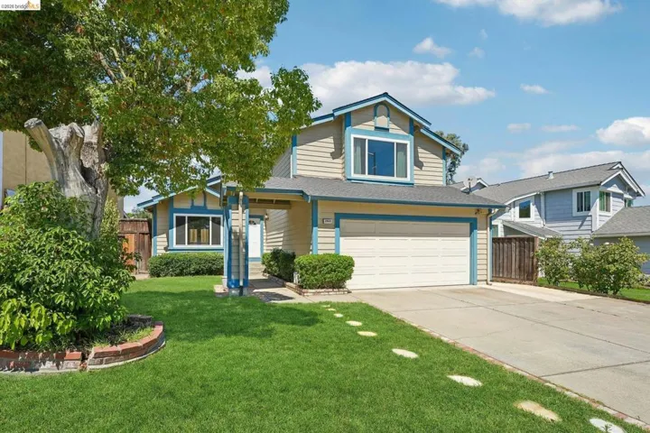 Two-story residence featuring light-colored siding and blue trim accents