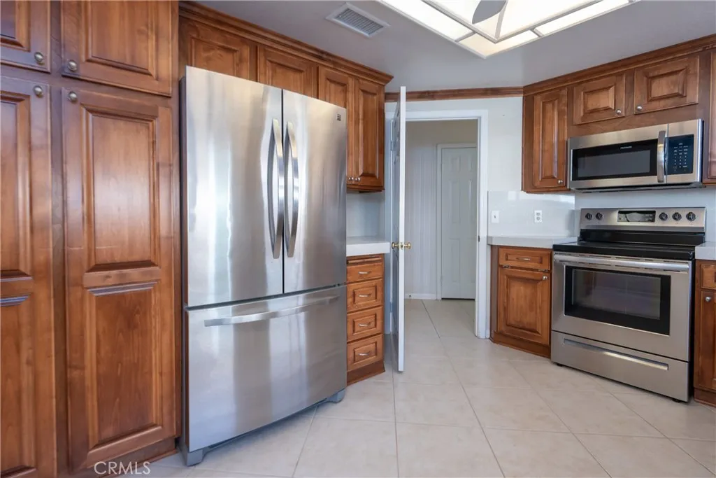 Lots of kitchen cabinets & stainless steel appliances
