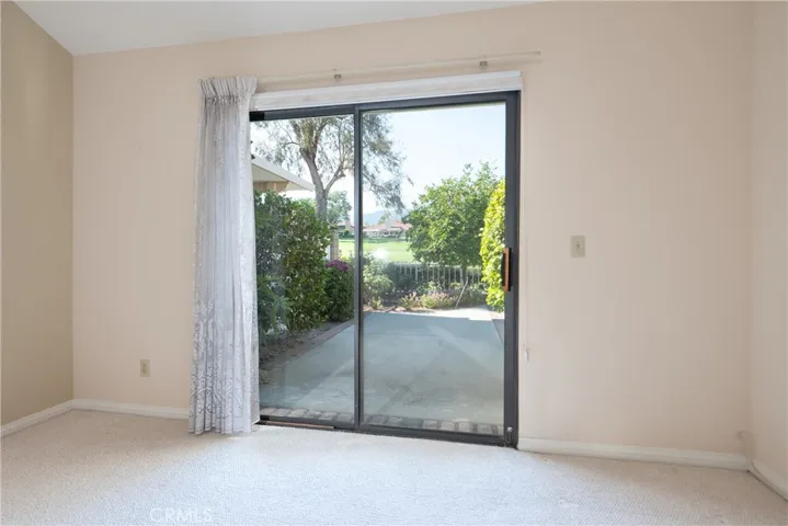 Primary bedroom glass slider opens to patio