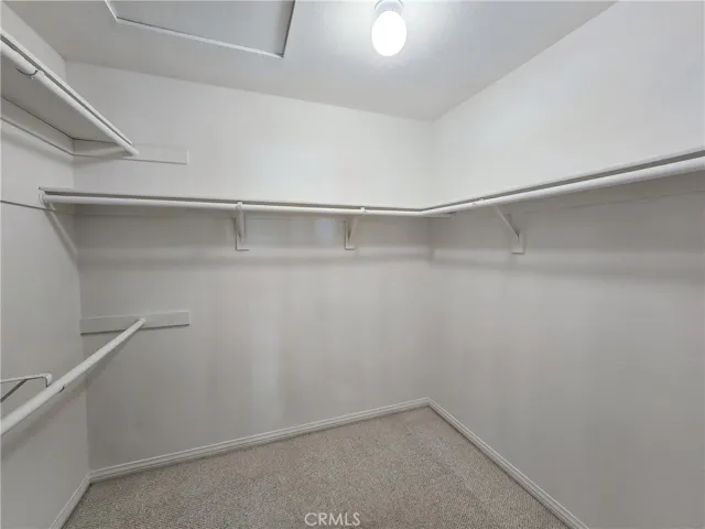 Primary bedroom walk-in closet