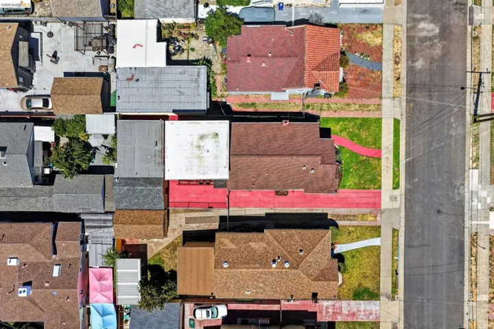 Residential properties featuring various roof styles and materials, including asphalt shingles, flat roofs, and terracotta tiles