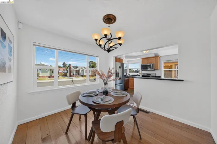 Dining area featuring wood-finish flooring and a multi-pane window
