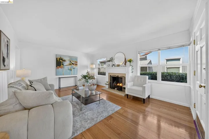 Living area featuring wood-finish flooring and a white fireplace mantel