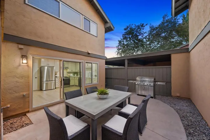 Large, fully-fenced patio with gate access to driveway. Photo is virtually staged. See uploaded unstaged photo for reference.