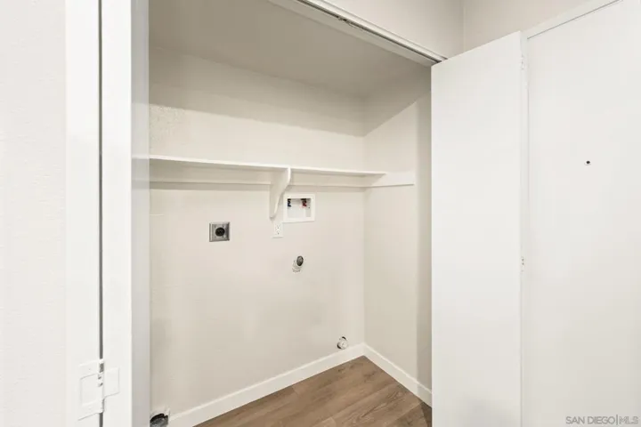 Full-size laundry closet in kitchen with electric hookups