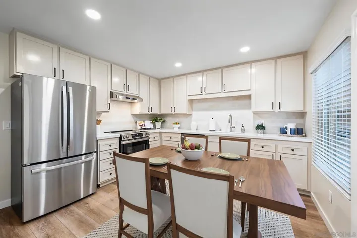 Newly remodeled, oversized, eat-in kitchen (17' x 12') with large pantry, brand-new stainless steel appliances, quartz countertops, and ceramic tile backsplash. Photo is virtually staged. See uploaded unstaged photo for reference.