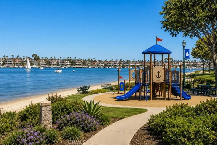 Nearby waterfront park with a children's playground, sandy beach, and Scenic Newport Harbor views