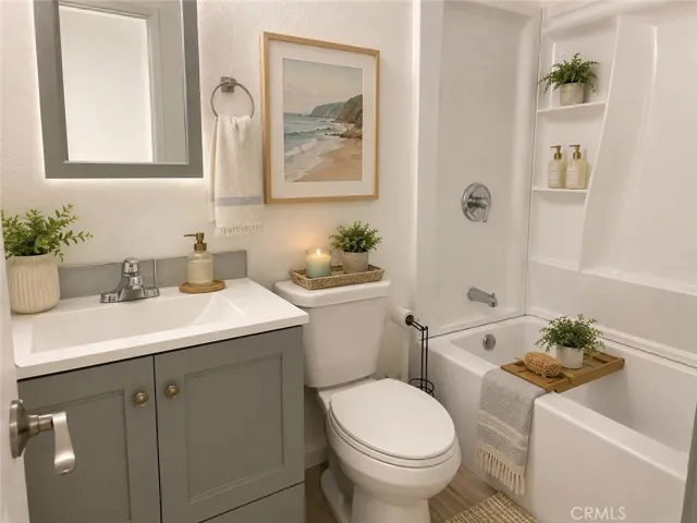 Updated full bathroom #1 featuring a modern vanity, tub/shower combination, and build-in storage