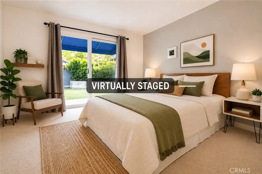 Spacious primary bedroom featuring a large sliding glass door with backyard access, abundant natural light, and plenty of room for a king-size bed and additional seating. (Virtually staged.)