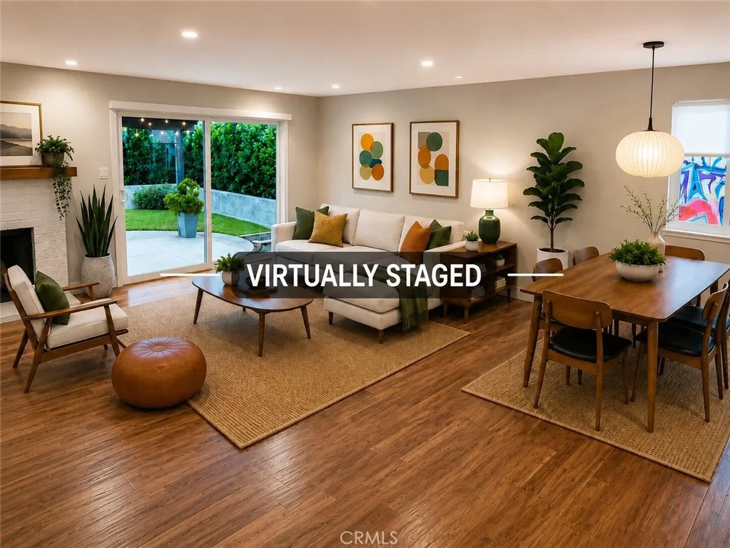 Beautifully designed spacious open-concept living and dining areas feature warm engineered hardwood floors, a charming corner fireplace, abundant natural light, and seamless indoor-outdoor flow through sliding glass doors to the beautifully landscaped backyard. (Virtually staged.)