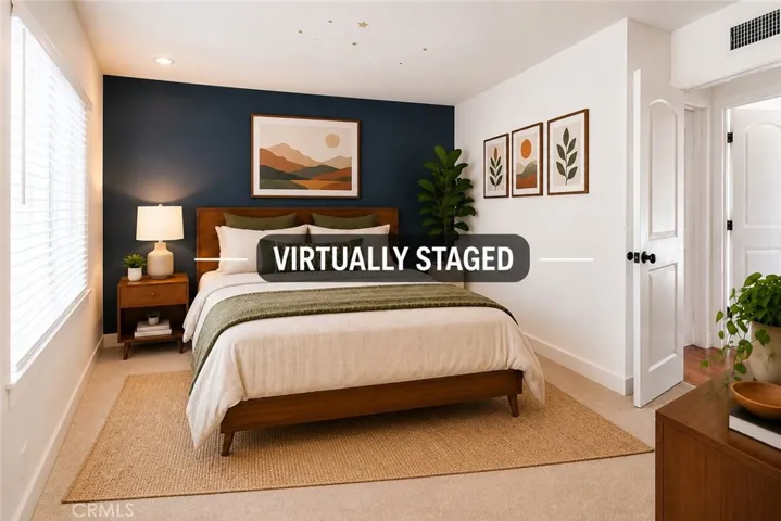 Spacious, one of four bedrooms featuring a striking accent wall, abundant natural light, and a flexible layout with room for a queen-size bed, making it ideal for family or guests. (Virtually staged.)