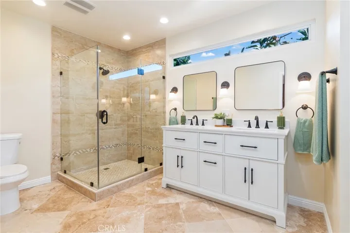 Primary Bathroom has walk in shower as well as a separate bathtub