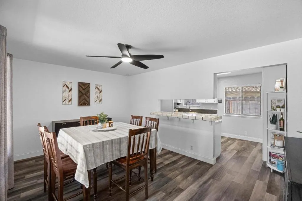 dining room well lit by natural light from the picture window and direct access to the kitchen