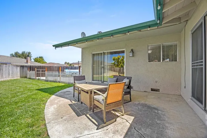 The patio is a nice way to enjoy the backyard space! Accessible from the living room & primary suite