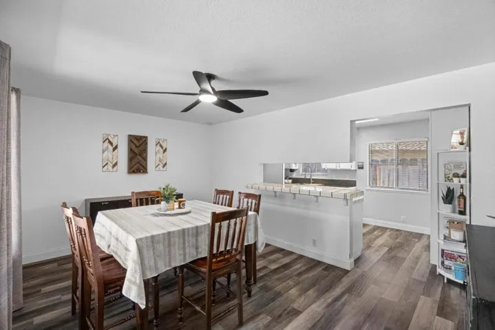 dining room well lit by natural light from the picture window and direct access to the kitchen