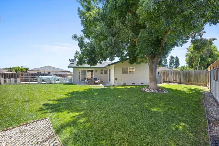 This backyard is NOT digitally enhanced so grab your lawn mower for this spacious yard!