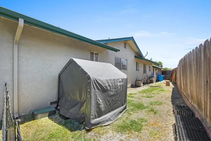 Spacious side yard serves as dog run, private & accessible from back yard, front gate or garage door