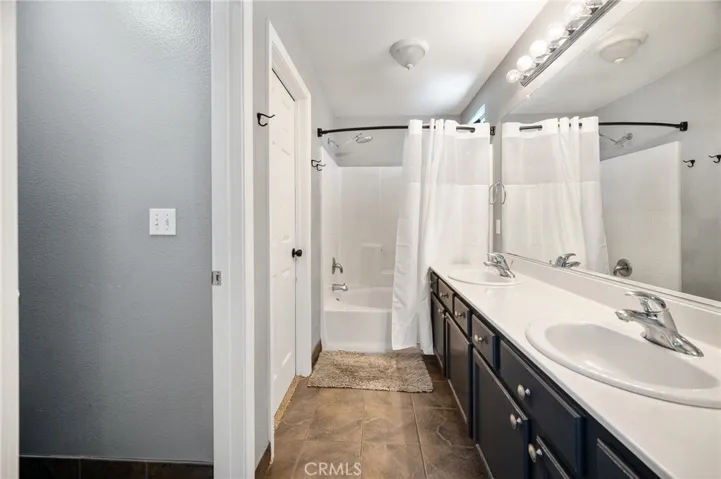 Spacious primary suite features a double vanity and walk-in closet.