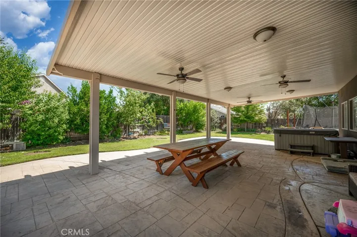 Large covered patio featuring ceiling fans and ample space for outdoor seating.