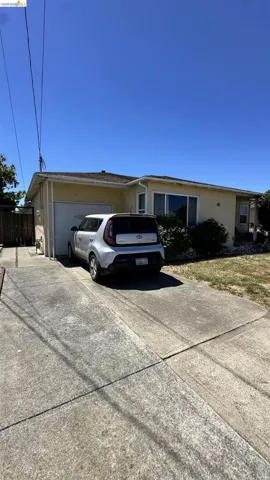 Single-story residence featuring a stucco exterior, attached garage, and a concrete driveway