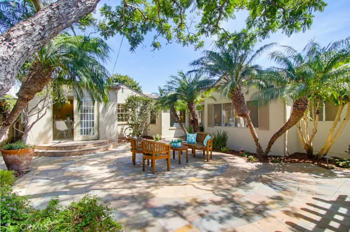 Back patio has two points of entrance in different wings of the house