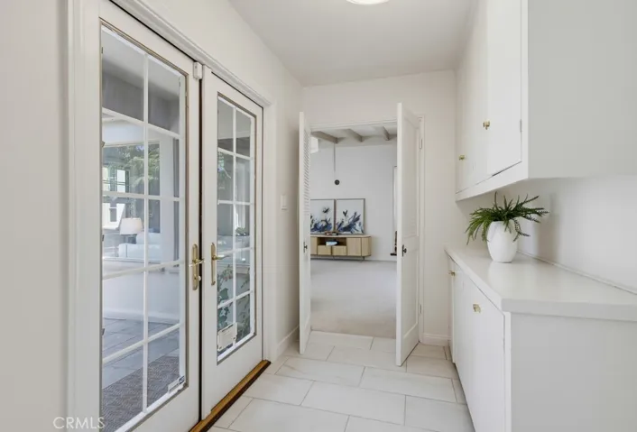 Hallway to back bedrooms with patio access doors