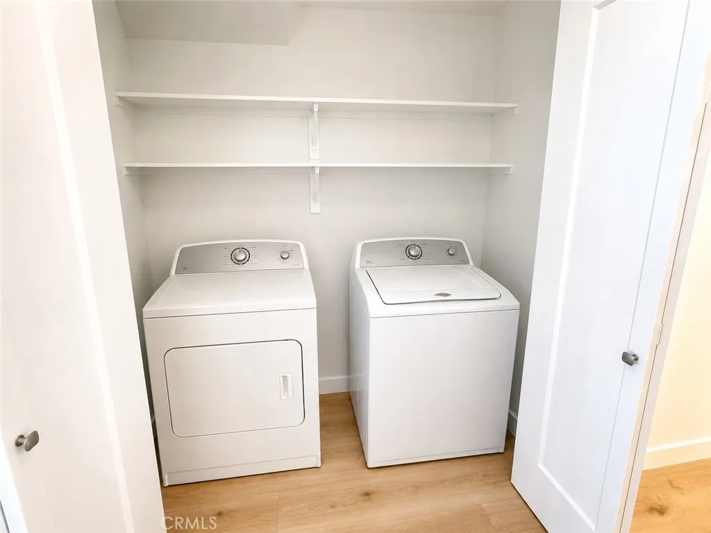 Washer and dryer in closet directly across kitchen.