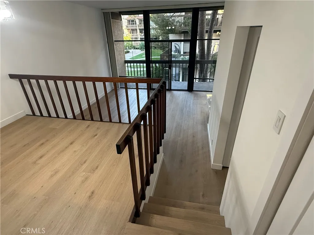 Another view from dining room into sunken living room including stairs down into living room.