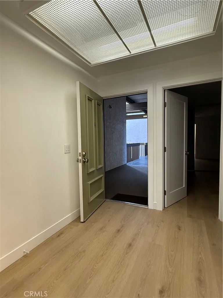 Main front door entry and adjacent primary bedroom entrance.