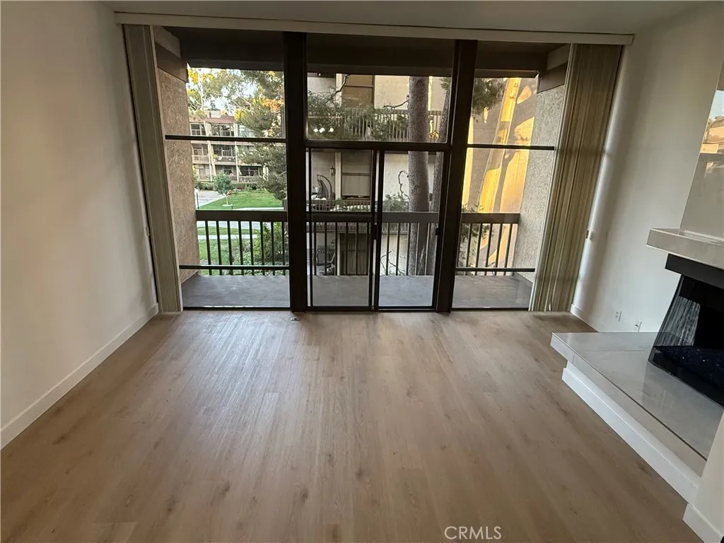 View of large windows, slider and living room balcony.