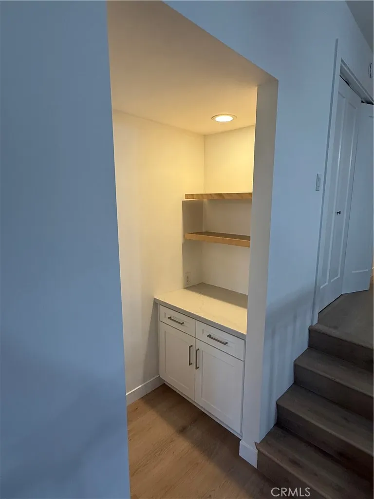 Workstation and office at base of stairs of living room.