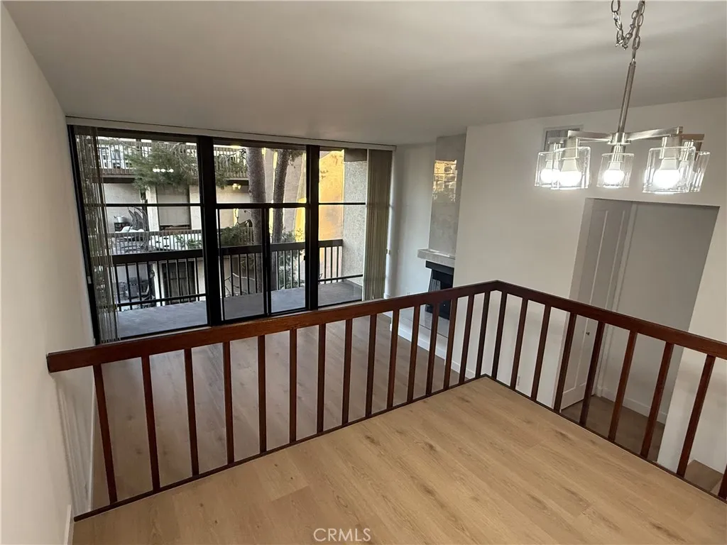 View from dining room into Sunken living room, large window and slider onto balcony.